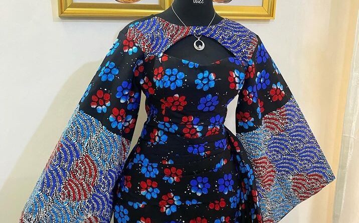 Designed with dramatic bell sleeves adorned in intricate wave patterns and a flattering cinched waist, this Afrocentric dress is perfect for weddings, church, and special occasions.